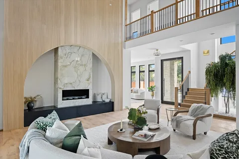 a living room with furniture and a potted plant