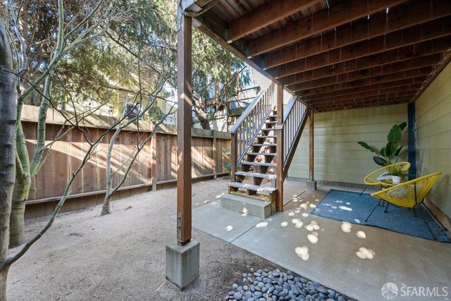 a roof deck with table and chairs a barbeque with potted plants