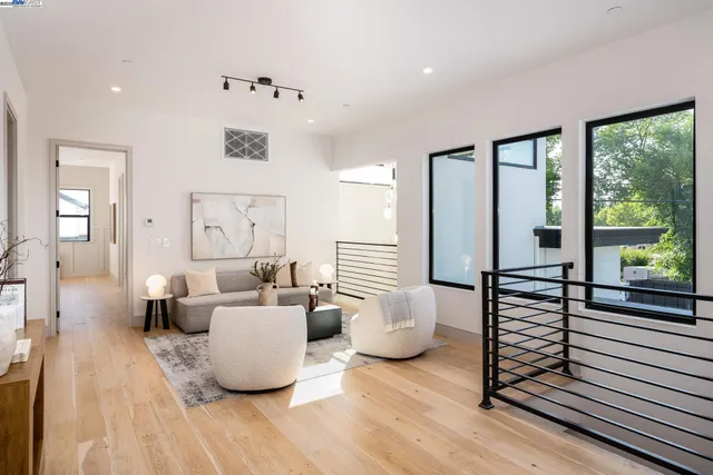 a living room with furniture and floor to ceiling windows