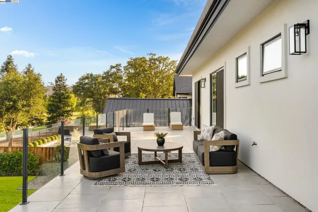 a view of a porch with furniture and garden