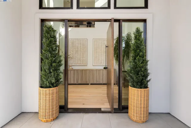 a room with a door and potted plant