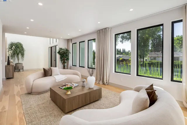 a kitchen with a table chairs and white cabinets