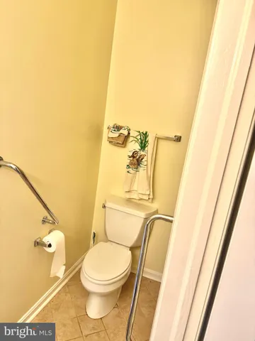 a white toilet sitting next to a sink