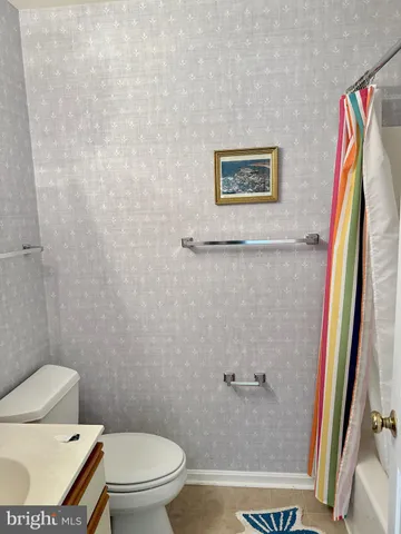 a white toilet sitting next to a bathroom sink