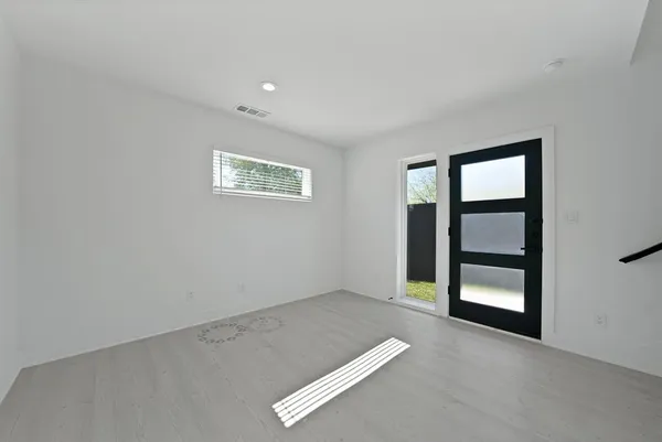 an empty room with windows and closet