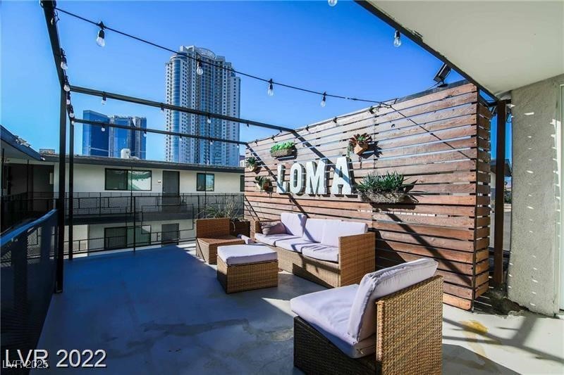 2201 Fairfield Avenue, Unit 21 Las Vegas, NV 89102 - Photo 2 of 7 View of patio featuring outdoor lounge area and a view of city