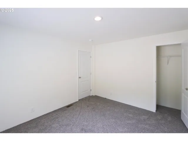 a view of an empty room and a window