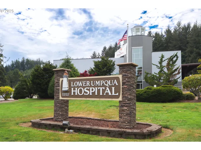 a sign board with a play ground in the back