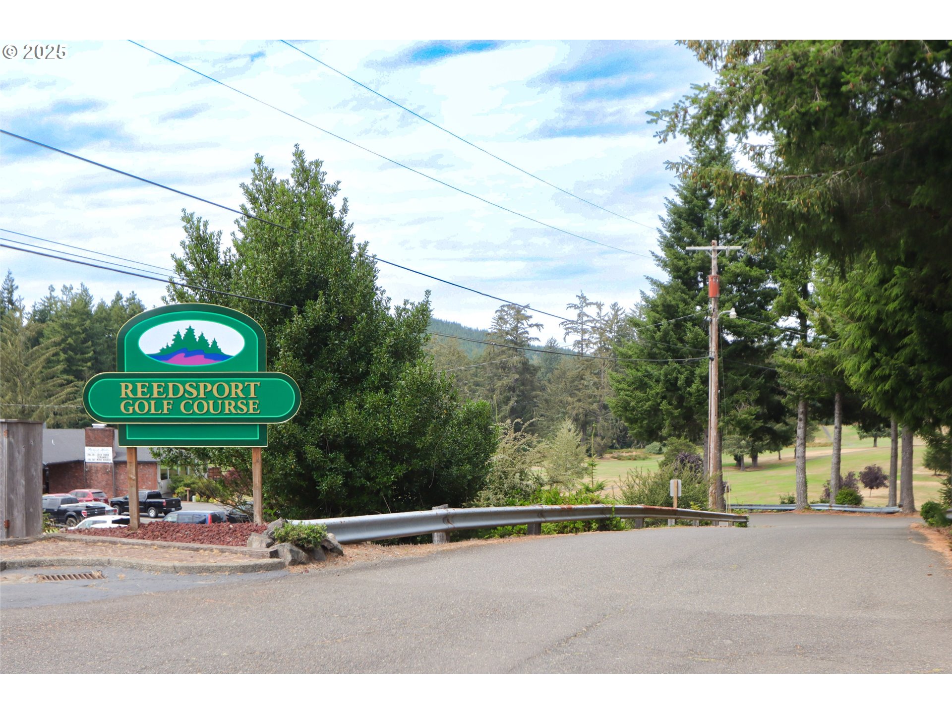 425 Providence Drive Reedsport, OR 97467 - Photo 28 of 33 a sign board with a play ground in the back