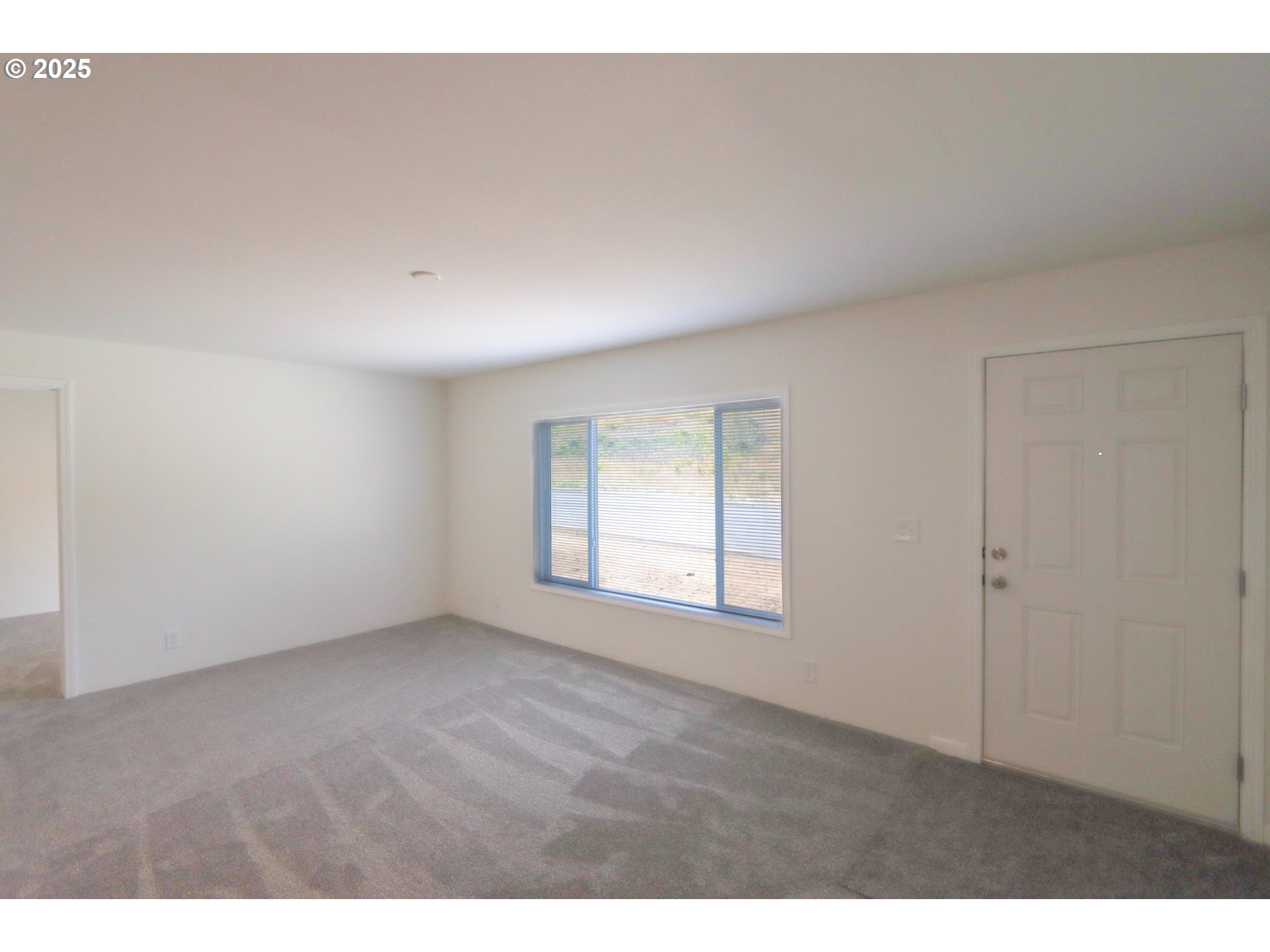 425 Providence Drive Reedsport, OR 97467 - Photo 4 of 33 a view of an empty room with a window