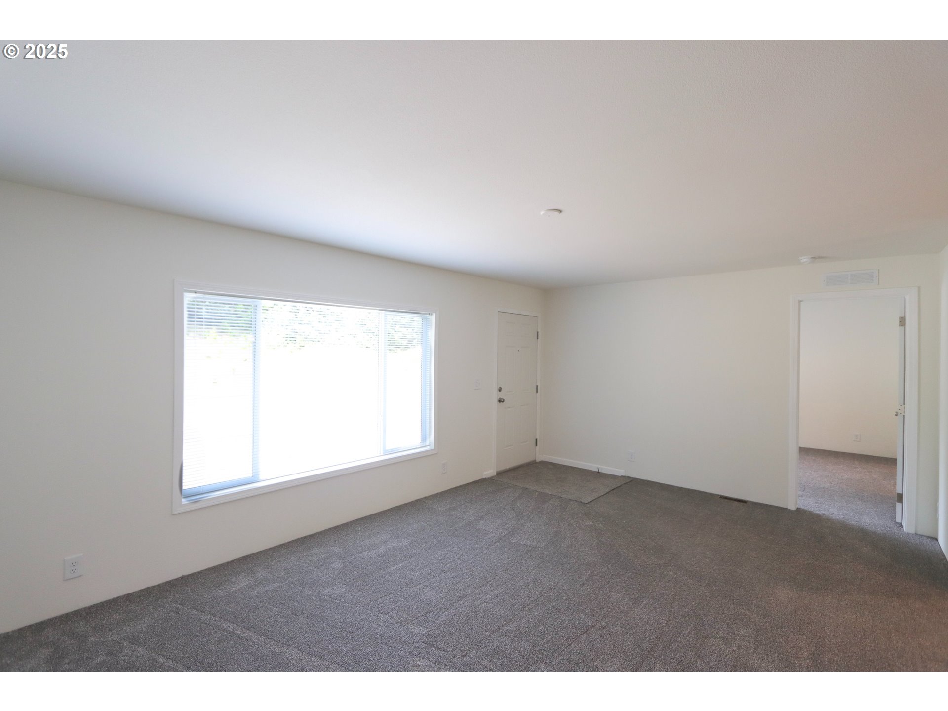 425 Providence Drive Reedsport, OR 97467 - Photo 5 of 33 a view of an empty room with a window