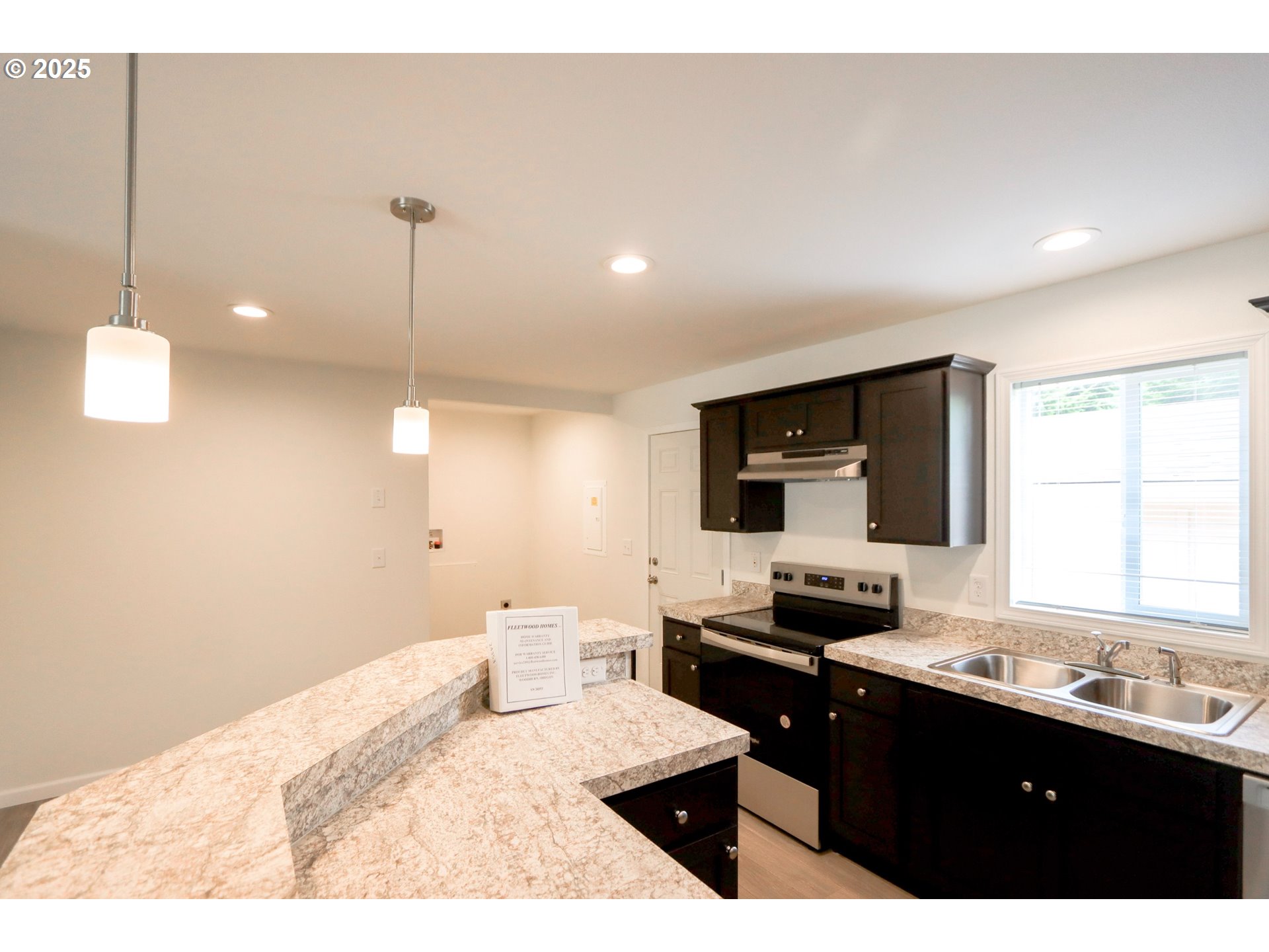 425 Providence Drive Reedsport, OR 97467 - Photo 8 of 33 a kitchen with a sink kitchen island and stainless steel appliances
