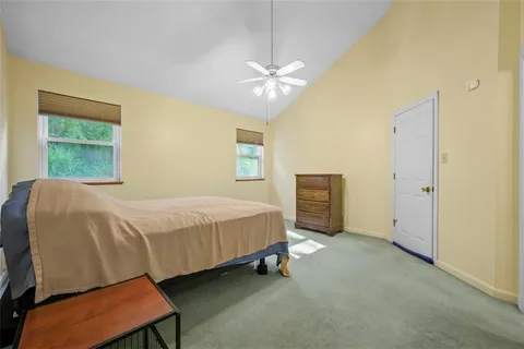 a bedroom with a bed dresser and a window