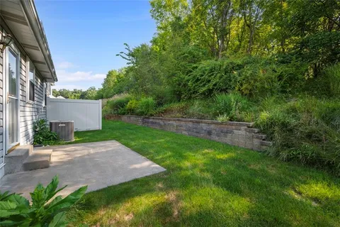 a view of backyard of house with green space