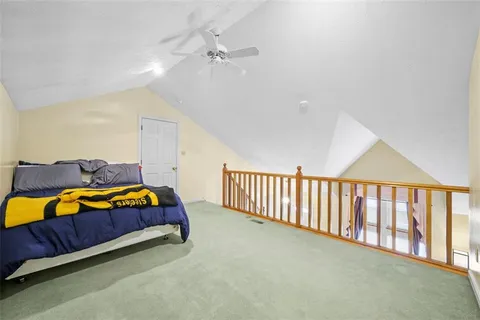 a spacious bedroom with a bed and a couch