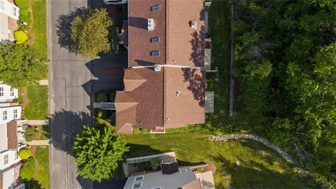an aerial view of a house with a yard pool patio and outdoor seating