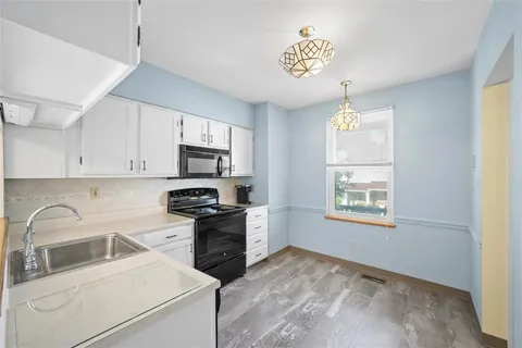 a kitchen with stainless steel appliances granite countertop a stove and a sink