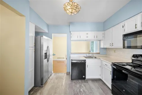 a kitchen with stainless steel appliances granite countertop a refrigerator and a stove top oven