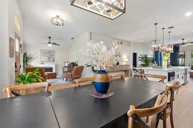 a living room with furniture a fireplace and a large window