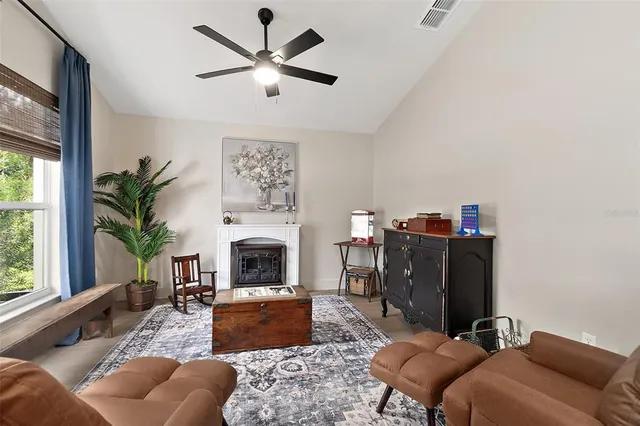 a living room with furniture a window and a fireplace