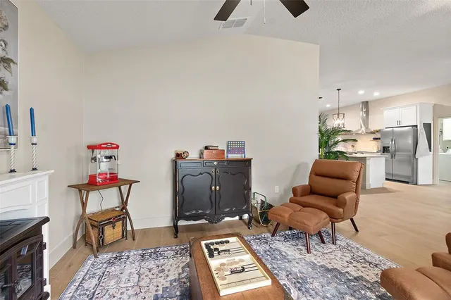 a living room with furniture kitchen view and a table