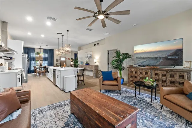 a living room with furniture potted plant and a large window