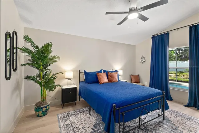 a bedroom with a bed and wooden floor