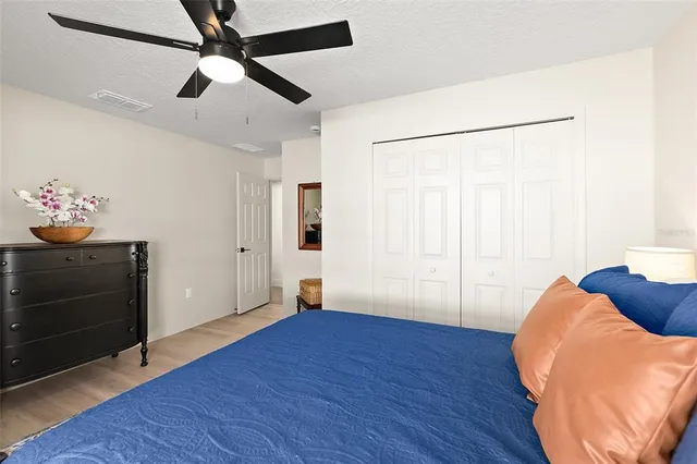 a bedroom with a bed a desk and chair