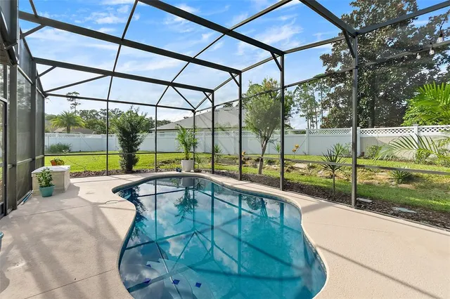 a view of backyard with plants and outdoor seating