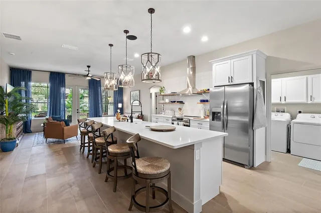 a kitchen with granite countertop a sink a center island stainless steel appliances and cabinets