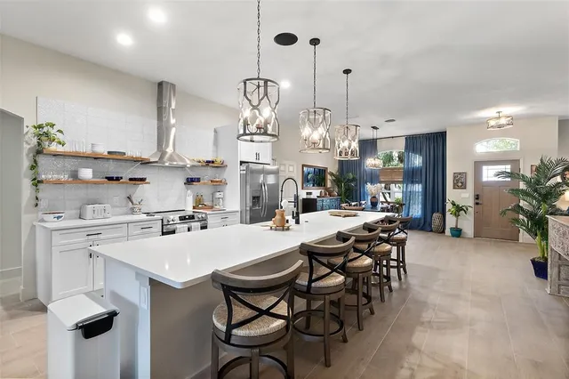 a large kitchen with a table and chairs