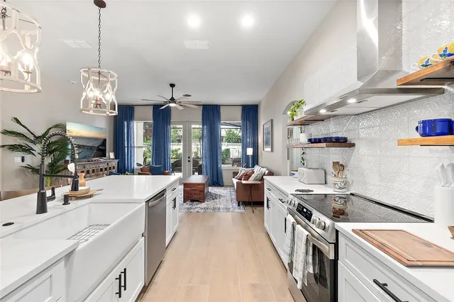 a open kitchen with stainless steel appliances granite countertop a sink stove and refrigerator
