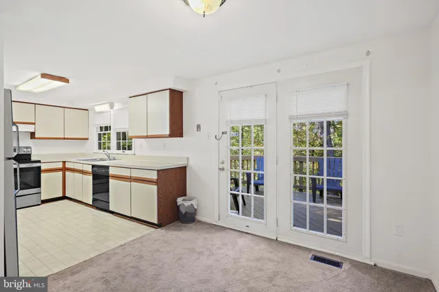 a view of staircase with lots of frames on wall and stairs