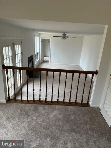 a view of a livingroom with a ceiling fan and window
