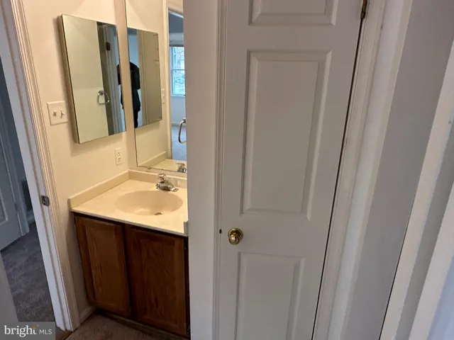 a view of a closet with wooden floor