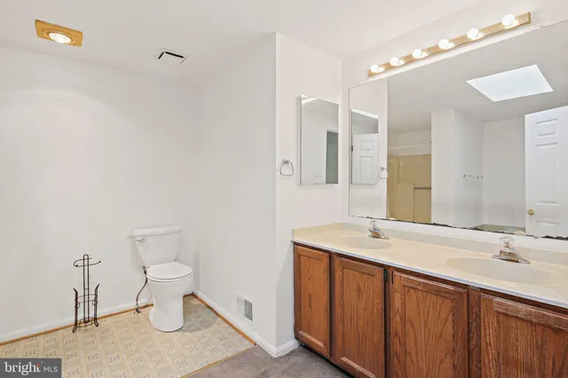 a bathroom with a sink toilet and vanity