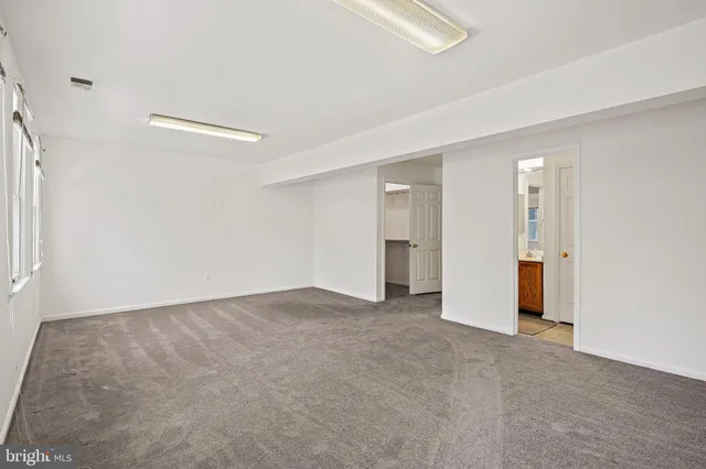 a view of an empty room with a bathroom