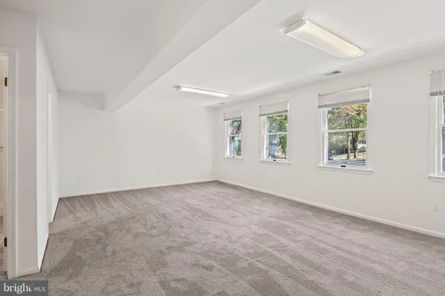 an empty room with a empty space and windows