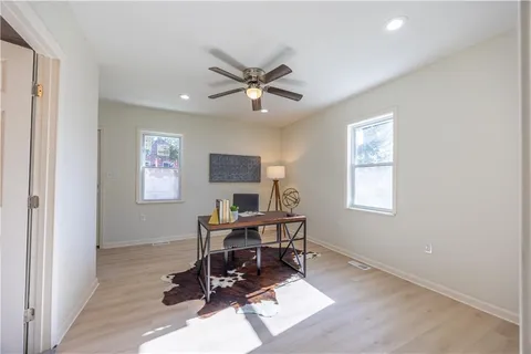 a workspace with wooden floor and a window