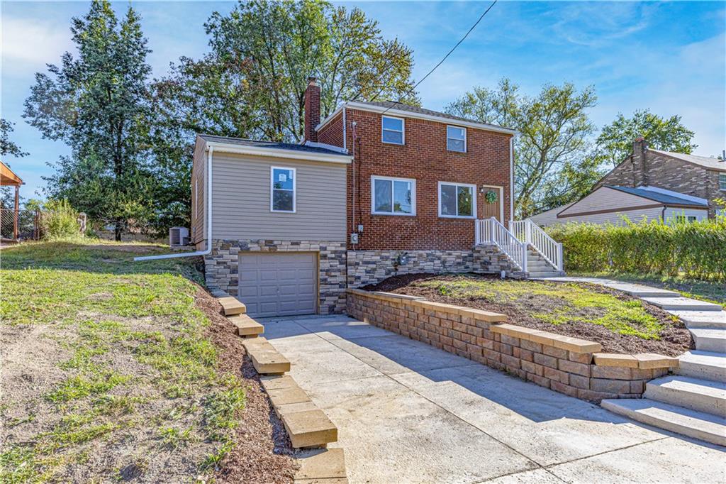 117 Oak Avenue Penn Hills, PA 15235 - Photo 2 of 26 a front view of a house with garden