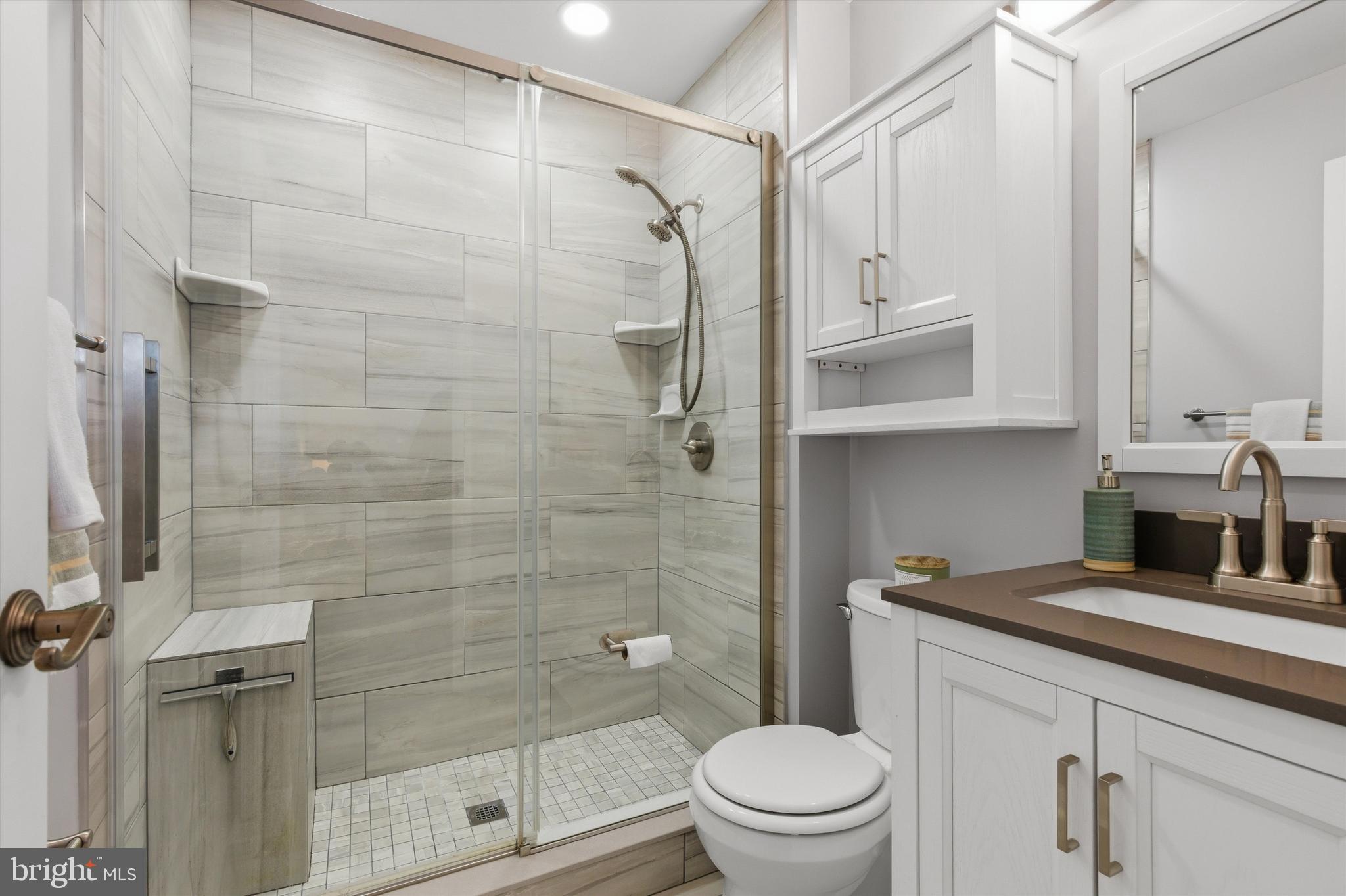 101 Cottage Grove Drive Pasadena, MD 21122 - Photo 15 of 35 a bathroom with a granite countertop sink a toilet and shower