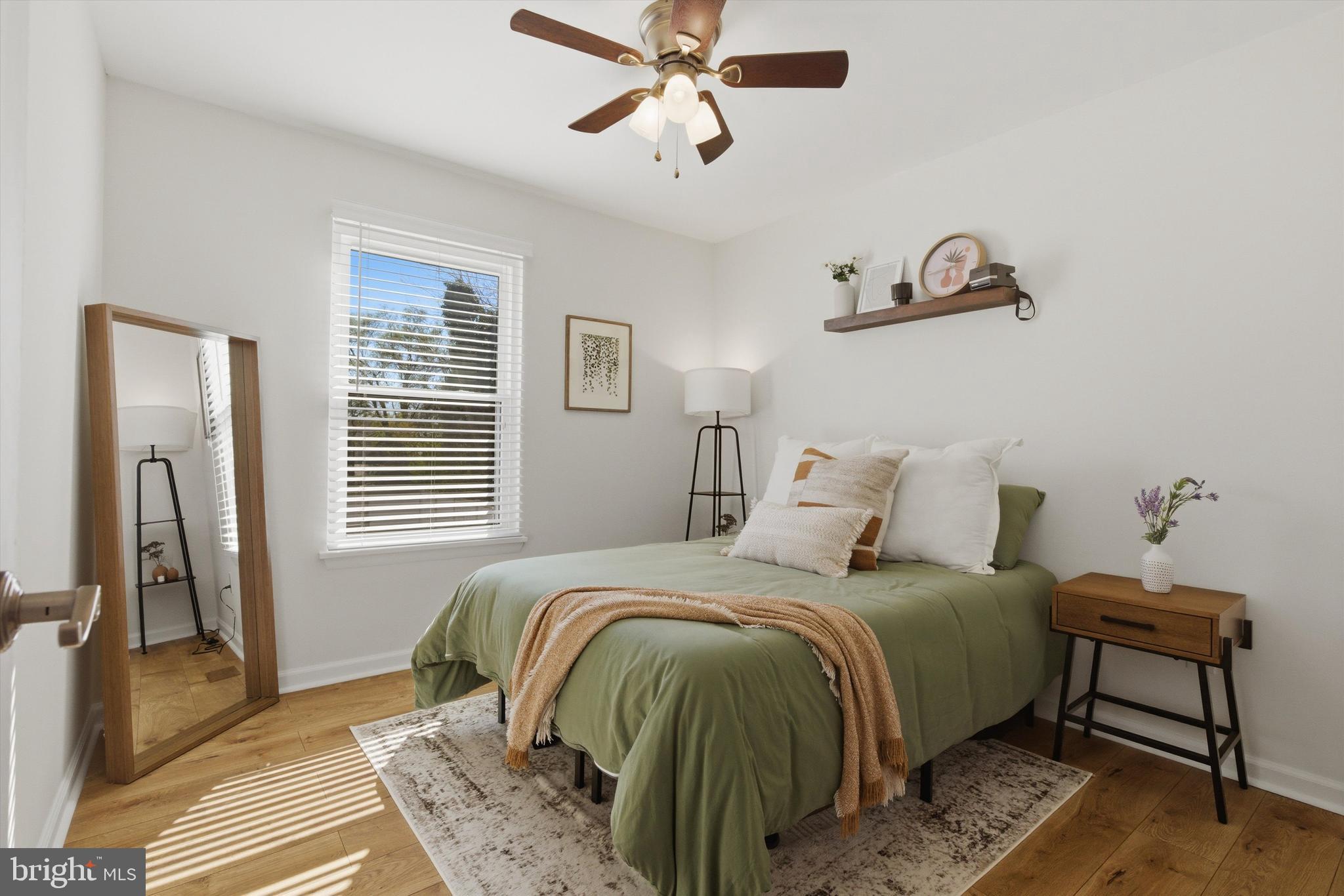 101 Cottage Grove Drive Pasadena, MD 21122 - Photo 16 of 35 a bedroom with a bed wooden floor and a window