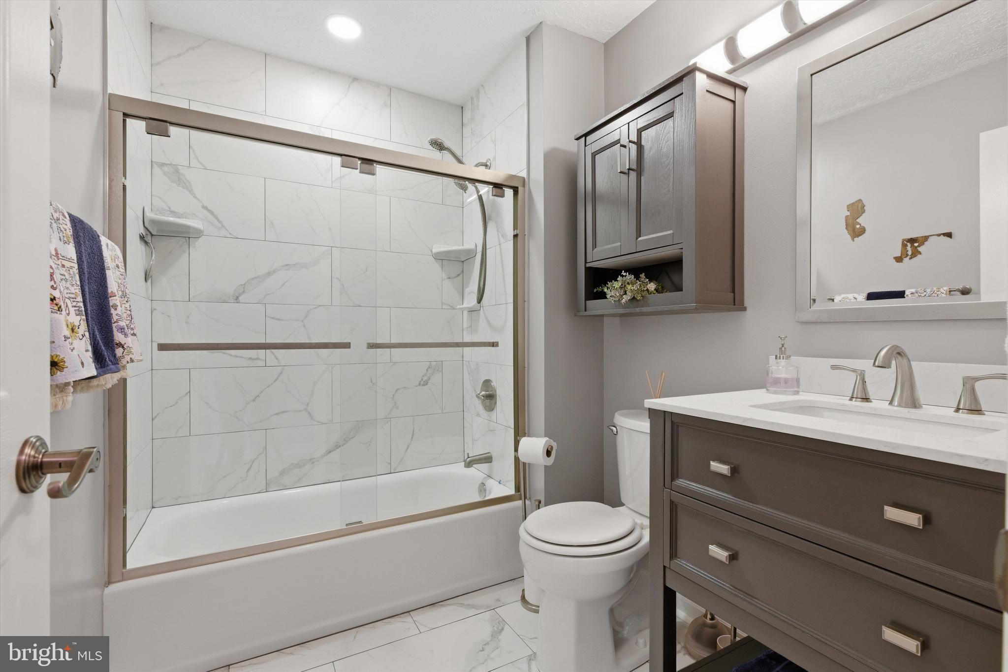 101 Cottage Grove Drive Pasadena, MD 21122 - Photo 19 of 35 a bathroom with a granite countertop sink a toilet and shower
