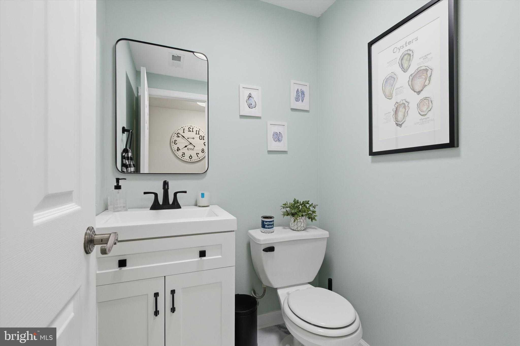 101 Cottage Grove Drive Pasadena, MD 21122 - Photo 22 of 35 a bathroom with a toilet sink and mirror