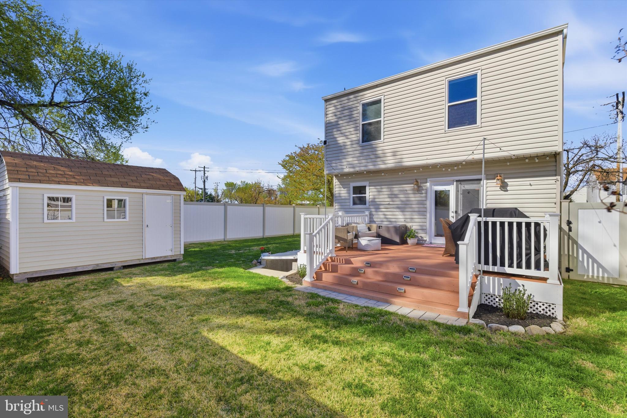 101 Cottage Grove Drive Pasadena, MD 21122 - Photo 27 of 35 a backyard of a house with table and chairs