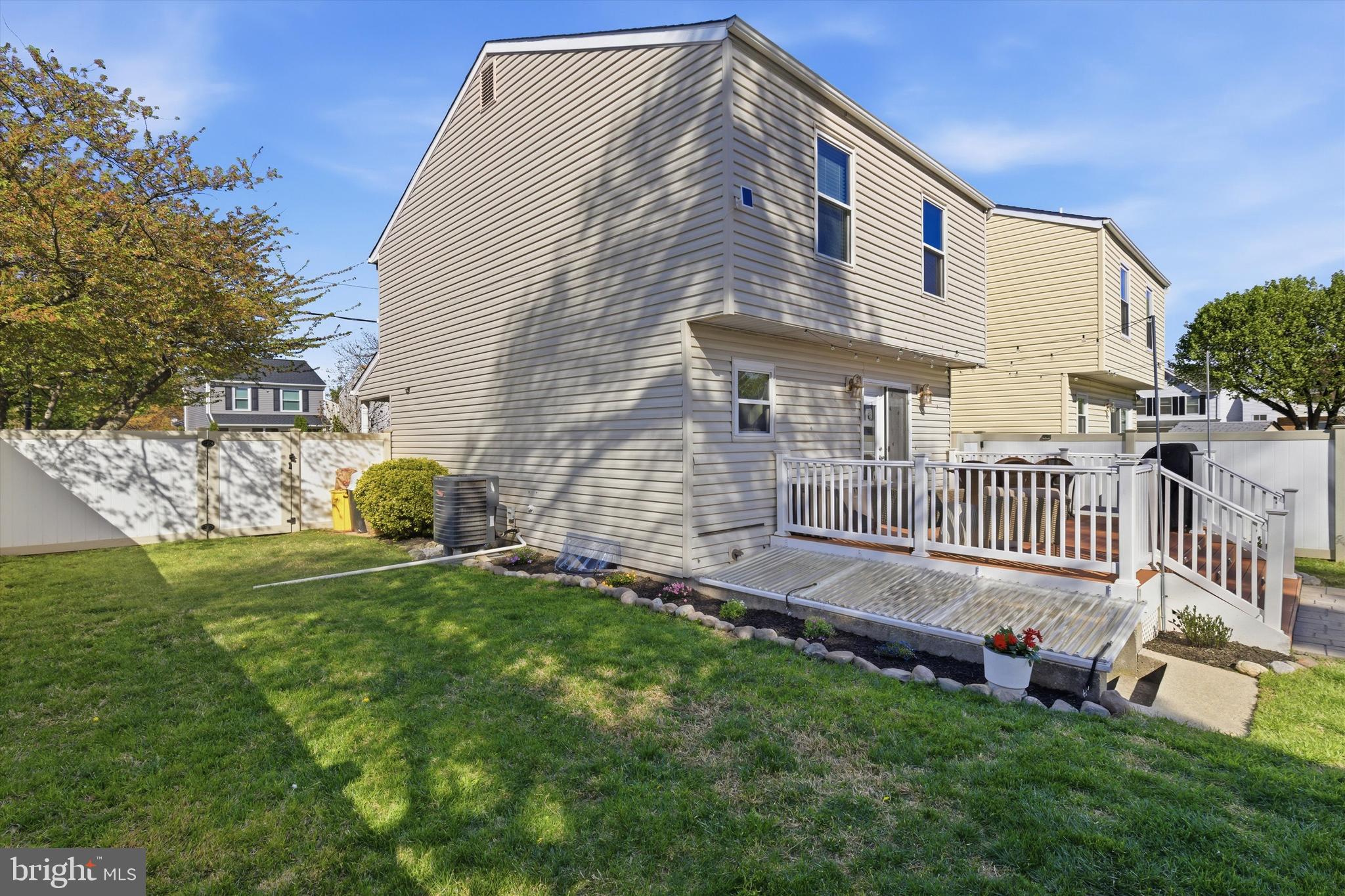 101 Cottage Grove Drive Pasadena, MD 21122 - Photo 28 of 35 a backyard of a house with table and chairs