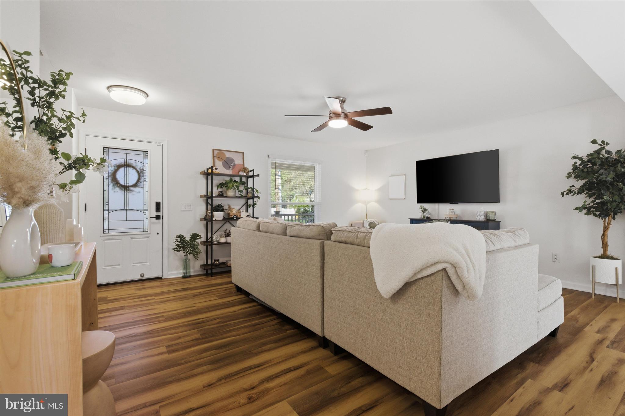 101 Cottage Grove Drive Pasadena, MD 21122 - Photo 6 of 35 a living room with furniture and a flat screen tv