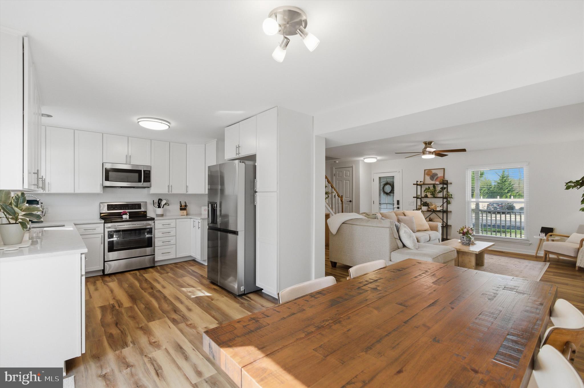 101 Cottage Grove Drive Pasadena, MD 21122 - Photo 8 of 35 a kitchen with refrigerator a sink and chairs