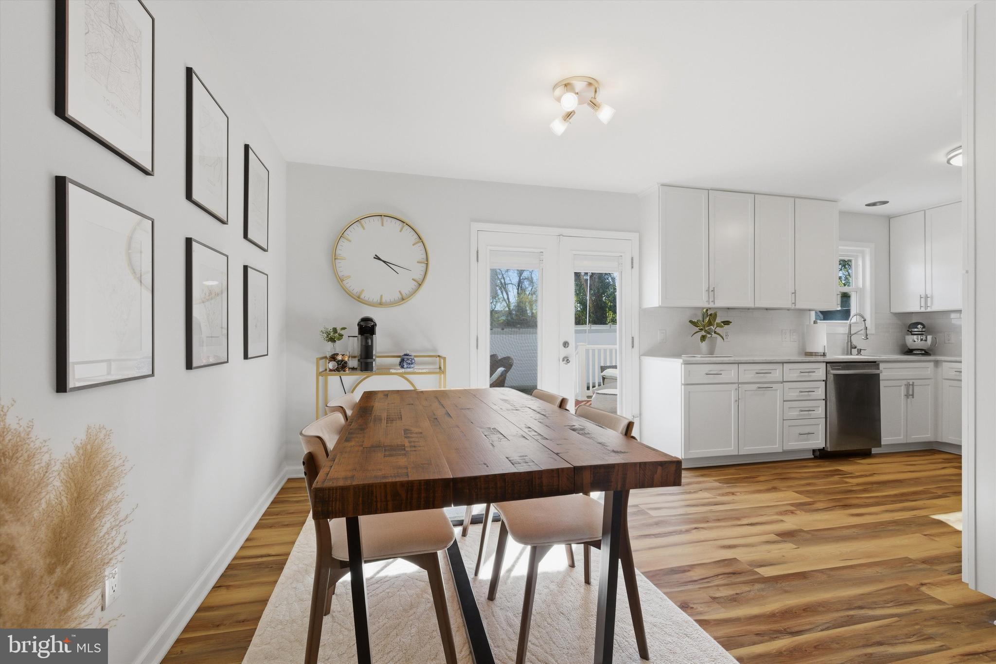 101 Cottage Grove Drive Pasadena, MD 21122 - Photo 9 of 35 a kitchen with a table chairs sink and cabinets