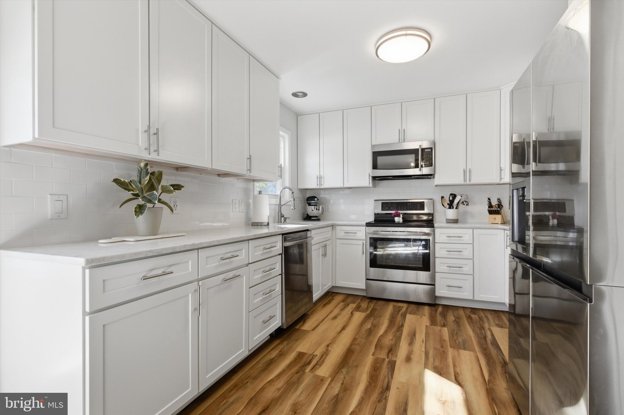 101 Cottage Grove Drive Pasadena, MD 21122 - Photo 10 of 35 a kitchen with cabinets stainless steel appliances and a counter space